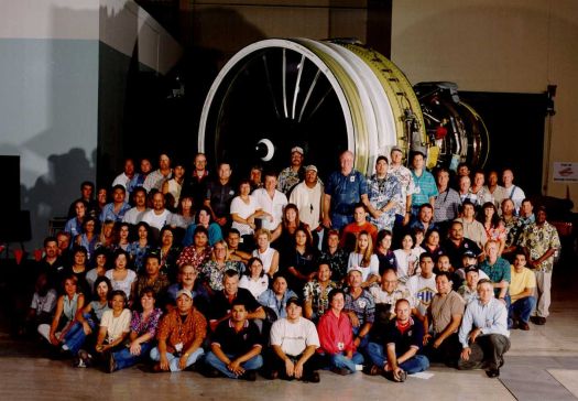 c-fan employees standing in-front of c-fan jet engine blades